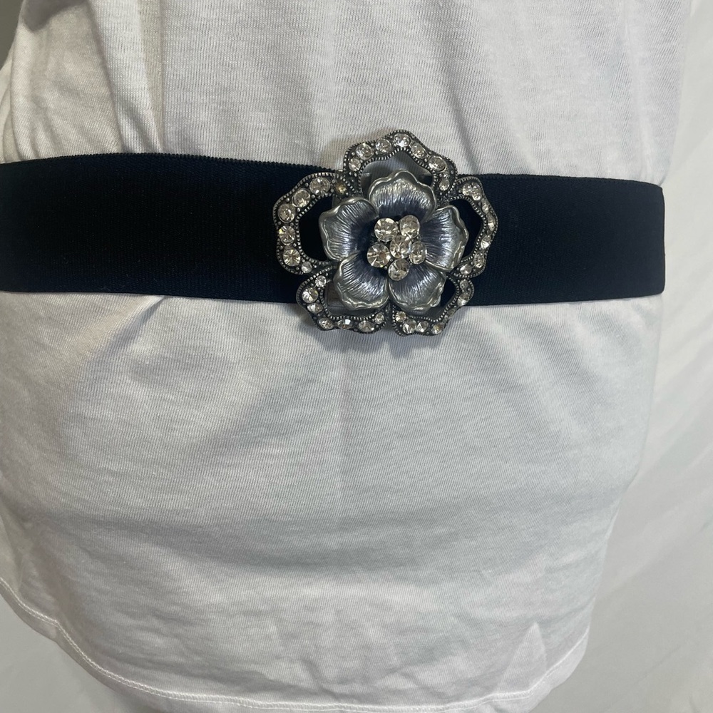 women's black stretch belt with a floral rhinestone buckle. Preowned. 30” to 52”